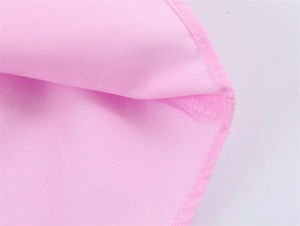 Detailed close-up of stitching and seam finishing on pink cotton poplin shirt