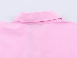 Detail of pink poplin shirt collar showing neat stitching and smooth fabric texture