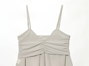 Close-up of light grey georgette camisole with V-neck pleats and adjustable straps