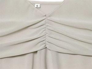 Detailed view of V-neck georgette top with pleated texture and fine lace stitching