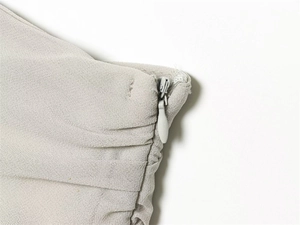 Close-up of the invisible zipper and fine pleated georgette fabric on the lace camisole