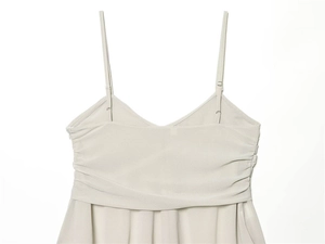 Detail of beige V-neck camisole top with pleated bust design and thin straps