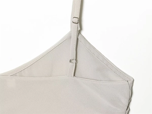 Detail of adjustable shoulder straps and neckline stitching on georgette lace camisole