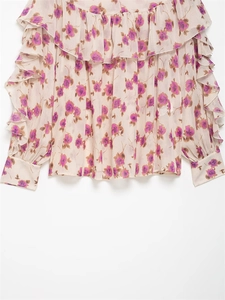 Detail of floral chiffon blouse featuring purple rose prints and ruffled sleeve edges
