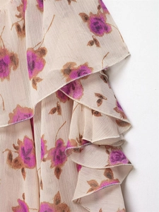 Detailed view of lightweight chiffon fabric with layered ruffles and vintage floral prints
