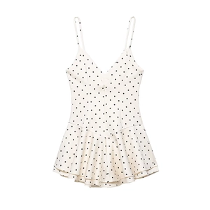 Chic off-white polka dot sleeveless romper dress with V-neck and ruffled hem details