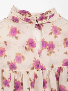 Detailed close-up of floral chiffon blouse with pleated high collar and keyhole back