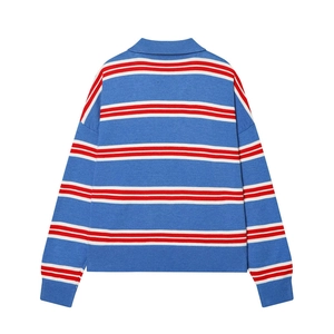 Detail of blue knit polo shirt with red and white stripes and ribbed cuff textures