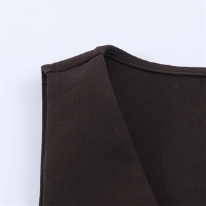 Detailed view of dark brown vest shoulder stitching and premium piped neckline finish