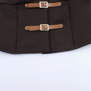Detail of dark brown vest waist with double faux leather straps and gold metal buckles
