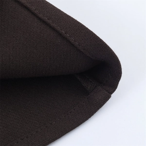 Detail of dark brown knitted vest showing high-quality stitching and fabric texture