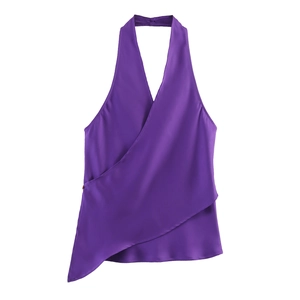Detail of purple satin halter top featuring a wrap design and asymmetric hem