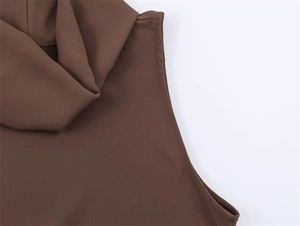 Detail of high collar pleats and stitching on brown sleeveless asymmetric top