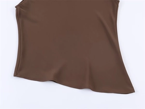Detailed view of the dark brown asymmetrical hem design on this stylish sleeveless top