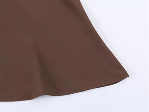 Detailed macro view of the mocha brown garment hem featuring precision single-needle stitching