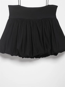 Detail of black balloon style camisole with thin straps and pleated puff hemline