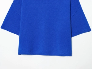 Détail du haut en maille bleu Klein montrant l'ourlet et la texture fine du tricot