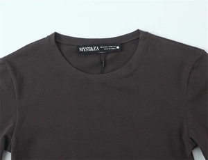 Close-up of neckline and brand label on a dark brown knit long sleeve t-shirt