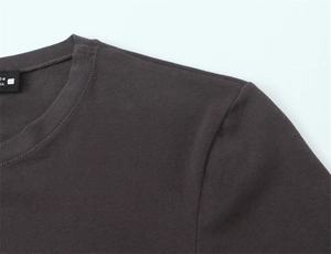 Close-up of crew neck ribbing and smooth shoulder seams on dark brown cotton t-shirt