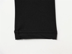 Detail view of the high-quality double-needle stitched hem on black slim-fit bodysuit