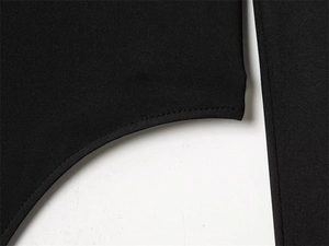 Detailed view of the clean stitching and elastic black fabric of this slim fit bodysuit