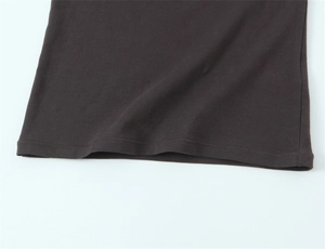 Close-up of dark brown cotton T-shirt hem with professional double-needle stitching detail