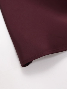 Macro shot of the wine red satin fabric showing high-quality stitching and smooth texture