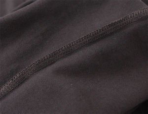 Detailed view of dark brown knitted fabric showing neat reinforced inner seam stitching