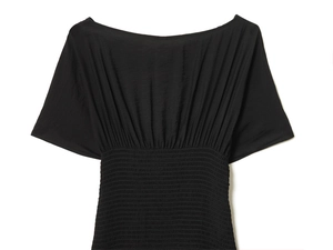 Detailed view of the smocking waist technique on a black off-shoulder fashion blouse