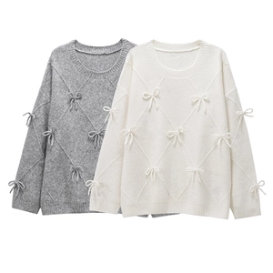 Women's loose knit sweater set with sweet bow accents and elegant diamond patterns