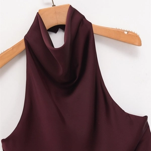 Elegant wine red satin halter top with high neck pleats hanging on a wooden hanger