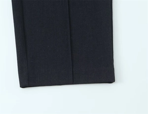 Vista dettagliata dell'orlo e della trama dei pantaloni neri a gamba dritta da donna