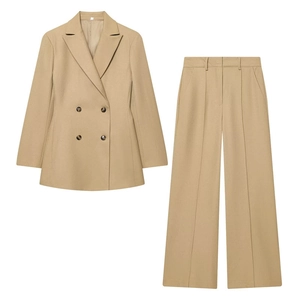 Detail of khaki double-breasted blazer and wide-leg trousers with sharp center creases