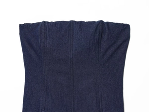 Macro detail of dark denim corset top showing vertical seams and twill fabric texture