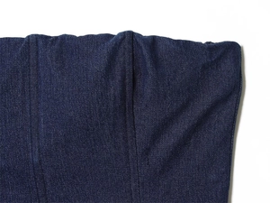 Detail view showing vertical seams and denim fabric texture on the dark blue corset top