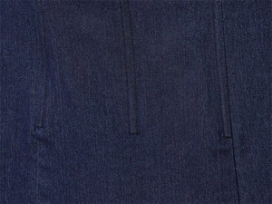 Macro shot of dark blue denim corset fabric with vertical seams and twill texture detail