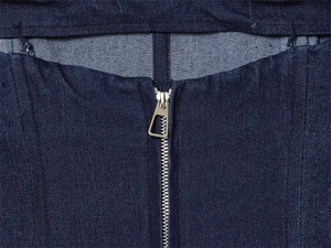 Detail of dark blue denim corset top featuring a silver triangular metal zipper pull