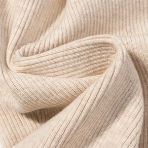 Macro shot of high-quality beige ribbed knit fabric texture for winter bodysuit
