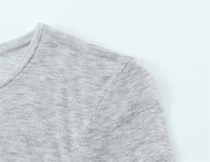 Detail shot of shoulder seams and grey heather knit texture on slim fit long sleeve tee