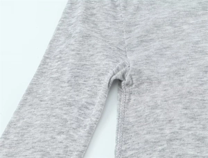 Detailed macro shot of grey knit fabric showing high-quality stitching and texture