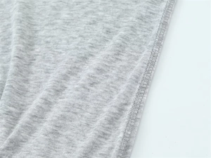 Close-up of grey knit fabric texture with high-quality double-needle stitching detail