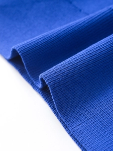 Detailed close-up of blue ribbed knit fabric showing elastic texture and soft weave