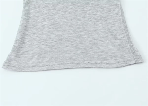 Detailed close-up of the double-needle stitching and grey knit fabric hem on the T-shirt