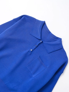 Detail of royal blue knit Polo shirt featuring chest pocket and three-button collar