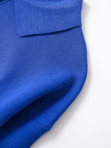 Detailed view of the royal blue knit fabric and clean stitching on the polo collar