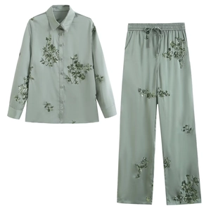Sage green two-piece satin set with floral sequin embroidery and elastic waist pants