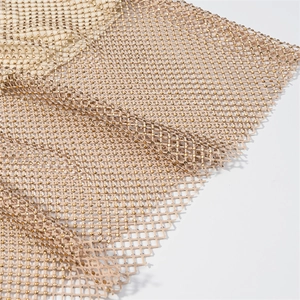 Detail of champagne gold rhinestone mesh fabric with glittering diamond pattern texture