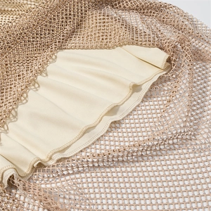 Close-up of champagne mesh dress featuring glittering rhinestones and fine edge stitching