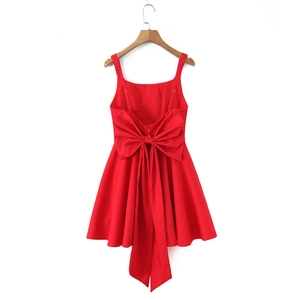Stunning back view of a red square neck mini dress featuring a large decorative bow