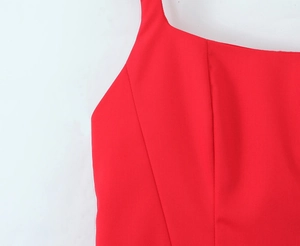 High-quality close-up showing vibrant red fabric and precise stitching on a square neck dress